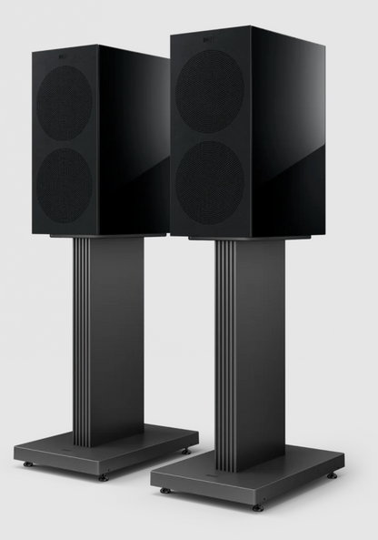 KEF R3 Meta Bookshelf Speakers in Gloss Black, with grille, on stands.