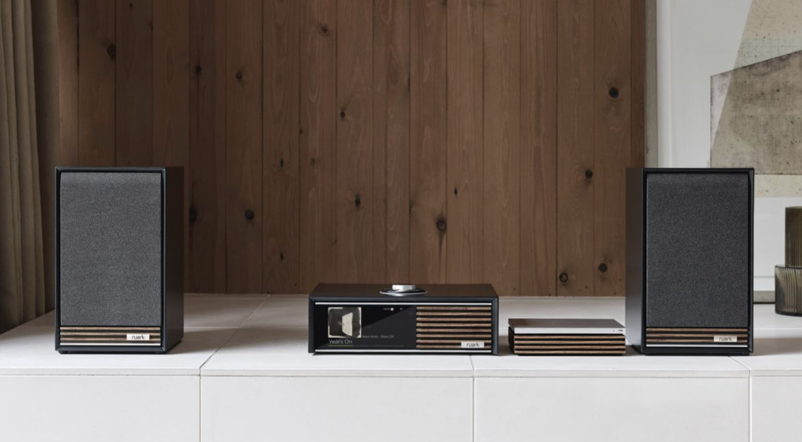 Ruark Audio R-CD100 CD Player, in room with Sabre-R Bookshelf Speakers and the R610 Music Console